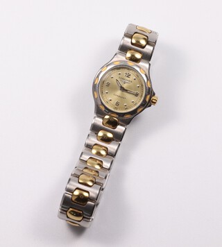 A lady's 2 colour Longines Conquest wristwatch with quartz movement, spare link and booklet 
