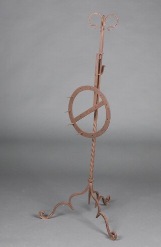 An 18th Century  wrought iron adjustable bar grate Lark spit, raised on tripod supports 125cm h, the revolving centre fitted 4 cooking prongs  