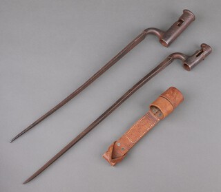 Two 18th Century socket bayonets, one with 44cm blade the other 40cm marked 214, together with a leather bayonet frog with broad arrow marked 88