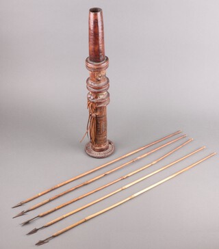 An Eastern leather quiver containing 5 bamboo shafted arrows with steel heads (1 arrow head a/f) 