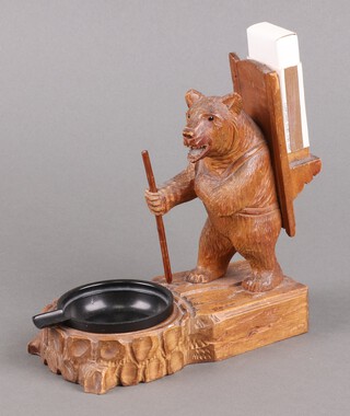 A 1930's carved Black Forrest ashtray decorated a hiking bear with match holder, the base no.12255 17cm x 15cm x 8cm 