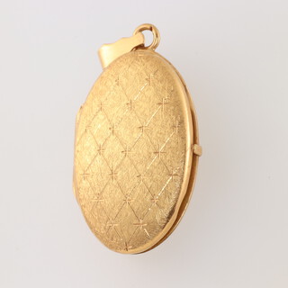A 22ct yellow gold engine turned Locket with inscription gross weight 12.4grams