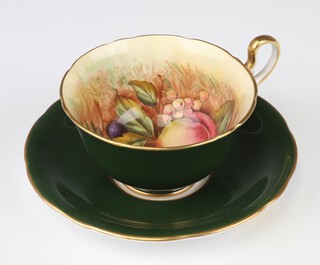 An Aynsley green and gilt glazed cup and saucer, the interior painted grapes and peaches, signed D Jones, the base with green Aynsley mark and N
