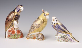 Three Royal Crown Derby Imari pattern paperweights - Bronzed winged parrot 2005 with gold stopper 16cm, Citron Cockatoo MMVIII  gold stopper 13cm, Violet Budgerigar MMVIII 10cm, all boxed 