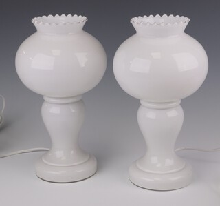 Heals, a pair of mid-Century opaque glass lamps incorporating bulbous lamp shades with wavy dots 28cm 