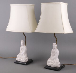 A pair of blanc de chine porcelain table lamps in the form of a seated Guanyin 27cm 