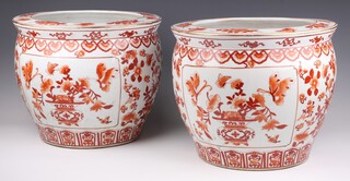 A pair of late 19th/early 20th Century ochre decorated jardinieres with panels of vases of flowers and insects, having a carp interior 30cm 