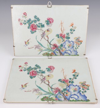 A pair of 20th Century Chinese rectangular wall plaques decorated with birds and insects amongst flowers 23cm x 34cm 