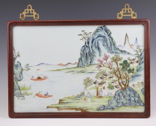 A 20th Century Chinese porcelain panel of an extensive landscape with figures before a village and in boats 25cm x 38cm, in a hardwood frame