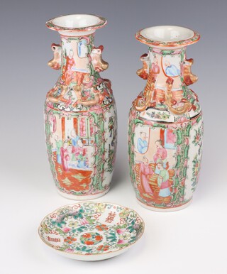 A pair of early 20th Century famille rose vases decorated with panels of figures and insects 24cm and a famille rose saucer 