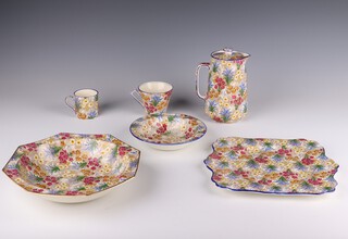 A Grimwades Royal Winton Marguerite pattern tea and coffee set comprising 5 coffee cans, 2 tea cups and 2 saucers (1 saucer A/F) a mug, 3 large saucers (1 A/F) a small tea pot and lid, 2 large jugs and lids (1 lid A/F) a small jug and lid, a cheese dish and lid, a small square bowl, a large milk jug, 3 sugar bowls, 4 small jugs (2 A/F) a large jug (A/F) a pedestal dish, 1 small plate, 1 square plate, a 2 handle dish (A/F) 6 saucers (4 A/F) a dessert bowl, 9 serving plates (5 A/F) and a fruit bowl