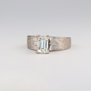 An 18ct white gold baguette cut diamond ring, the centre stone 0.7ct, the 2 baguette diamonds 0.1ct in total, maker Manning, size J, 4.8 grams