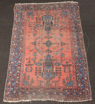 A pink and blue ground North Persian rug with central medallion and 2 rectangular medallions 179cm x 117cm 