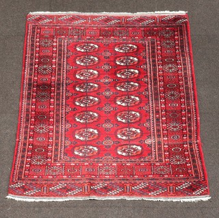 A red and white ground Bokhara rug with 16 octagons to the centre 112cm x 91cm 