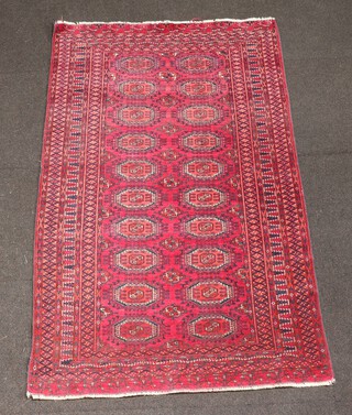 A red and blue ground Bokhara rug with 20 octagons to the centre within a multi row border 168cm x 101cm 
