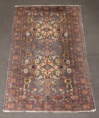 A blue, green and white ground Caucasian style rug with 2 stylised medallions to the centre 198cm  x 119cm