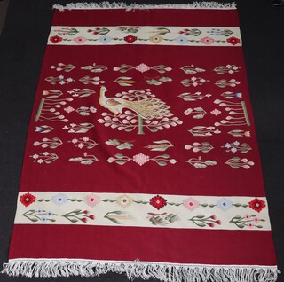 A red and white floral ground Aubusson style rug, the centre decorated a peacock 241cm x 171cm 
