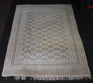 A white and blue ground Bokhara carpet with approx. 99 octagons to the centre 293cm x 223cm 