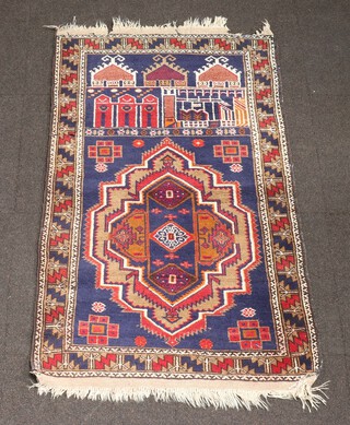 A blue ground Afghan rug with stylised buildings and medallion 145cm x 82cm 