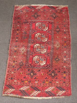 A red and blue Afghan rug with 4 octagons to the centre within a multi row border 180cm x 104cm 