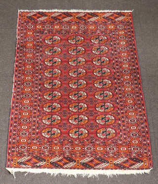 A red and blue ground Bokhara rug with 27 octagons to the centre 153cm x 102cm 