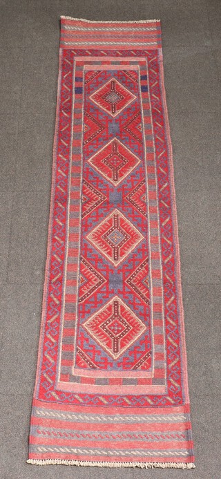 A red and blue ground Meshwani runner with 4 octagons to the centre 245cm x 58cm