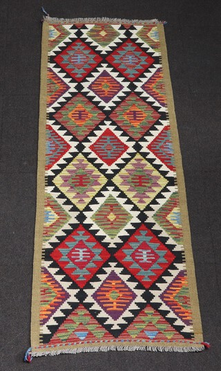 A black, white and red ground Maimana Kilim runner with all over geometric designs 194cm x 70cm  