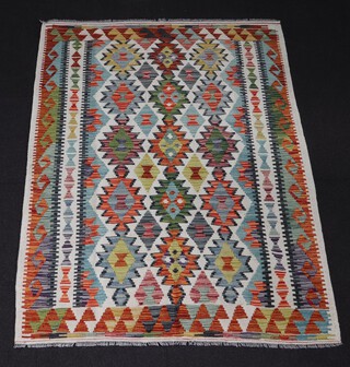 A white, green and brown ground Chobi Kilim with overall geometric designs 173cm x 127cm 