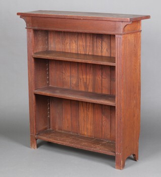 An Edwardian oak open bookcase with fluted columns to the sides 113cm h x 107cm w x 29cm d 