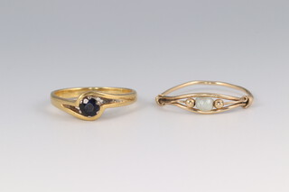 An 18ct yellow gold ring size L 1/2 3 grams, a 9ct gem set ditto size Q 1/2 0.7 grams 