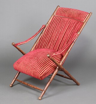 An Edwardian faux bamboo campaign style folding armchair 94cm x 60cm x 70cm, upholstered in gold and red striped material (seat 31cm x 40cm)  