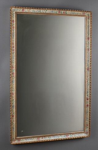 A 1920's rectangular plate mirror contained in a decorative gilt and floral patterned frame 105cm h x 66cm w  