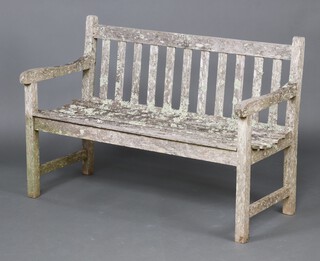 A well weathered slatted garden bench 82cm h x 121cm w x 55cm d 
