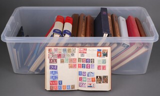 A collection of GB and world stamp albums, some empty, contained in a plastic box 