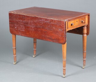A Victorian mahogany Pembroke table fitted a drawer, raised on turned supports ending in brass casters 70cm h x 89cm w x 50cm d (damage to rule joint)