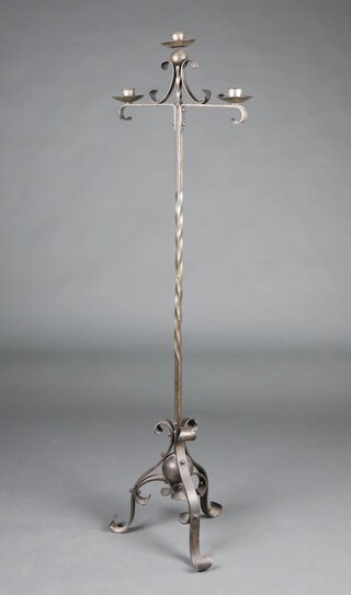A wrought iron 3 light standard lamp on a tripod base 145cm h 