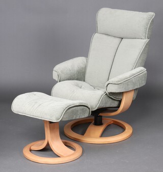 A G-Plan revolving armchair and matching footstool upholstered in blue material 100cm h x 72cm w x 60cm d 