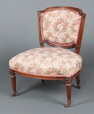 An Edwardian tub back show frame chair upholstered in tapestry material, raised on turned supports, brass caps and casters 72cm h x 59cm w x 50cm d 