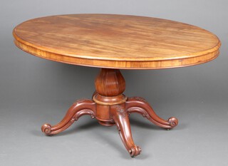 A Victorian bleached mahogany oval breakfast table raised on a carved column with tripod supports 73cm h x  147cm h x 103cm d 