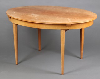 An oval teak mid-Century extending dining table raised on square supports with concealed extra leaf 75cm h x 97cm w x 138cm l (water and contact marks in places) 