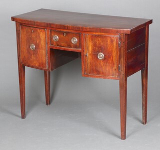 A 19th Century crossbanded mahogany bow front sideboard fitted a drawer flanked by cupboard and drawer, raised on square tapered supports 85cm h x 104cm w x 47cm d  