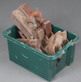 Three large 19th Century wooden jack planes, a wooden moulding plane, 3 smoothing planes, contained in a green crate and 2 carpenter's braces, various bits, chisels, 2 tenon saws, (all rusted and contained in a cardboard box) 