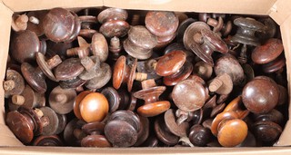 A large collection of 19th Century and later turned wooden chest handles and door knobs and a large collection of 19th Century turned wooden handles, contained in a cardboard box 