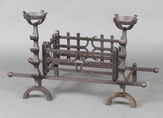 A wrought iron fire basket 24cm h x 49cm w x 31cmd,  complete with fire dogs 58cm x 47cm x 18cm 
