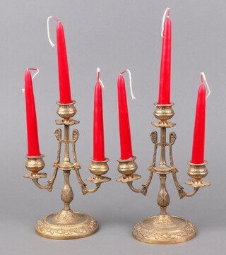 A pair of Empire style gilt metal 3 light candelabrum on circular bases 21cm h (sconces possibly missing) 