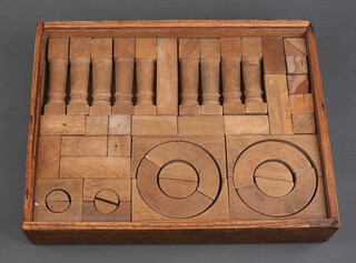 A set of vintage wooden building blocks in a wooden tray 