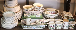 A quantity of Portmeirion Botanic Gardens tableware comprising 6 mugs, 6 egg cups, rounded dish, serving dish, 6 coasters, jug, bowl and platter, 6 serving implements, a casserole, 3 dessert bowls, 2 casseroles, cheese knife and spreaders, 9 large saucers, 4 side plates, 6 side plates, 13 dinner plates, 9 dessert plates, 10 soup bowls