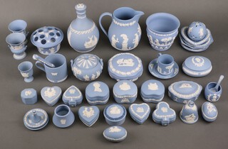 A quantity of Wedgwood pale blue Jasperware china comprising a jug, decanter, vases, boxes, dishes etc 