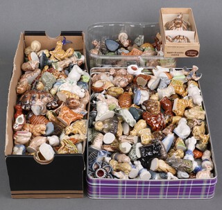 A large collection of Wade Whimsies figures of animals, 2 Wade figures of tortoise and a wooden display rack 