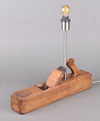 A table lamp, the base a wood carving plane 